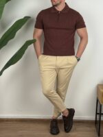Braon polo majica sa zipom kombinovana sa bež pantalonama, kadar celog tela