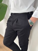 Bočni stav crnih elegantnih muških pantalona sa podesivim pojasom kraj stolice